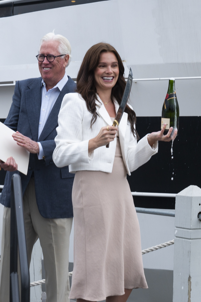 Caroline Jacobs performs the christening of the Lady Caroline with a bottle of Moët & Chandon champagne